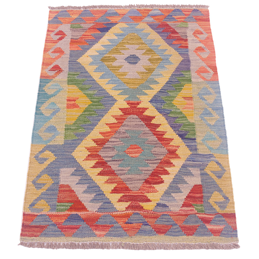 A small woven kilim rug with a colourful geometric diamond pattern, featuring fringed edges on a plain white background.