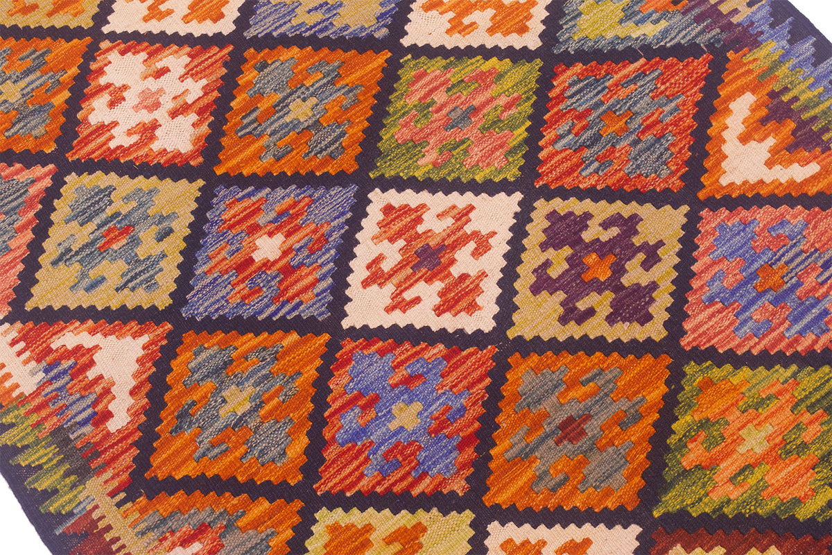 Close up detail of Afghan kilim in warm bright colours