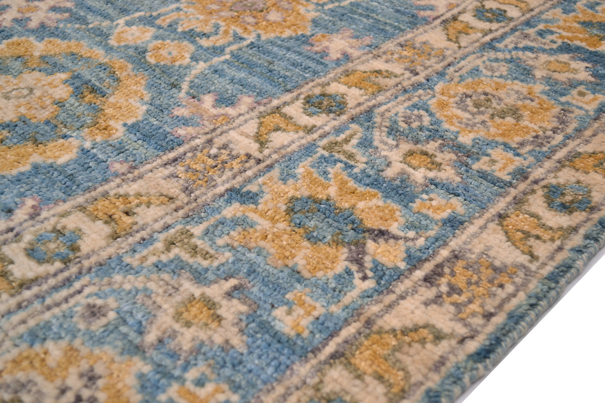 Detail of handknottign border of Abshari Ushak Carpet with cream, gold and turquoise