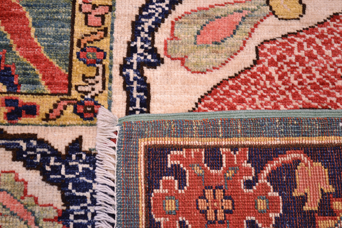 Reverse of carpet showing back of knots and handknotting and red wefts. Woven on a wool foundation. PIle cut show to detailing and antique like finish.