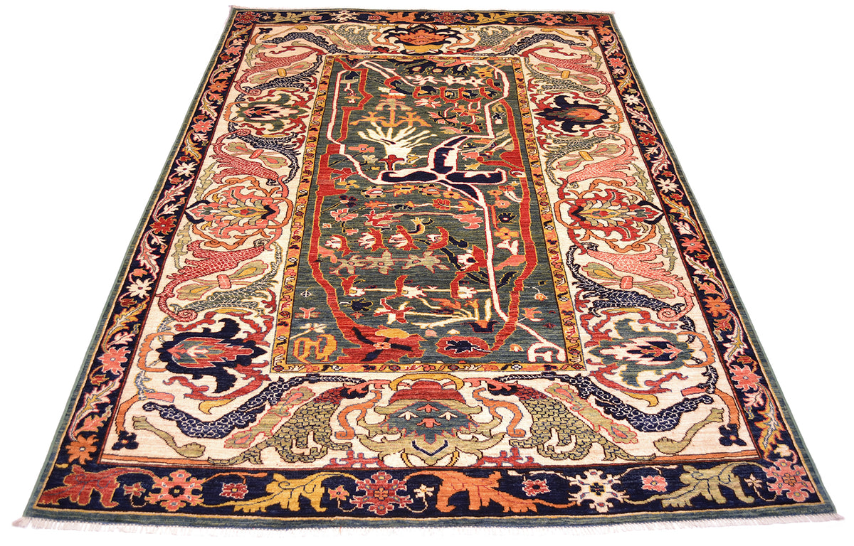 Rich tonalities and expanisive design of antique style carpet in multiple colours of green, dark blue, cream, gold terracotta and coral pinks.