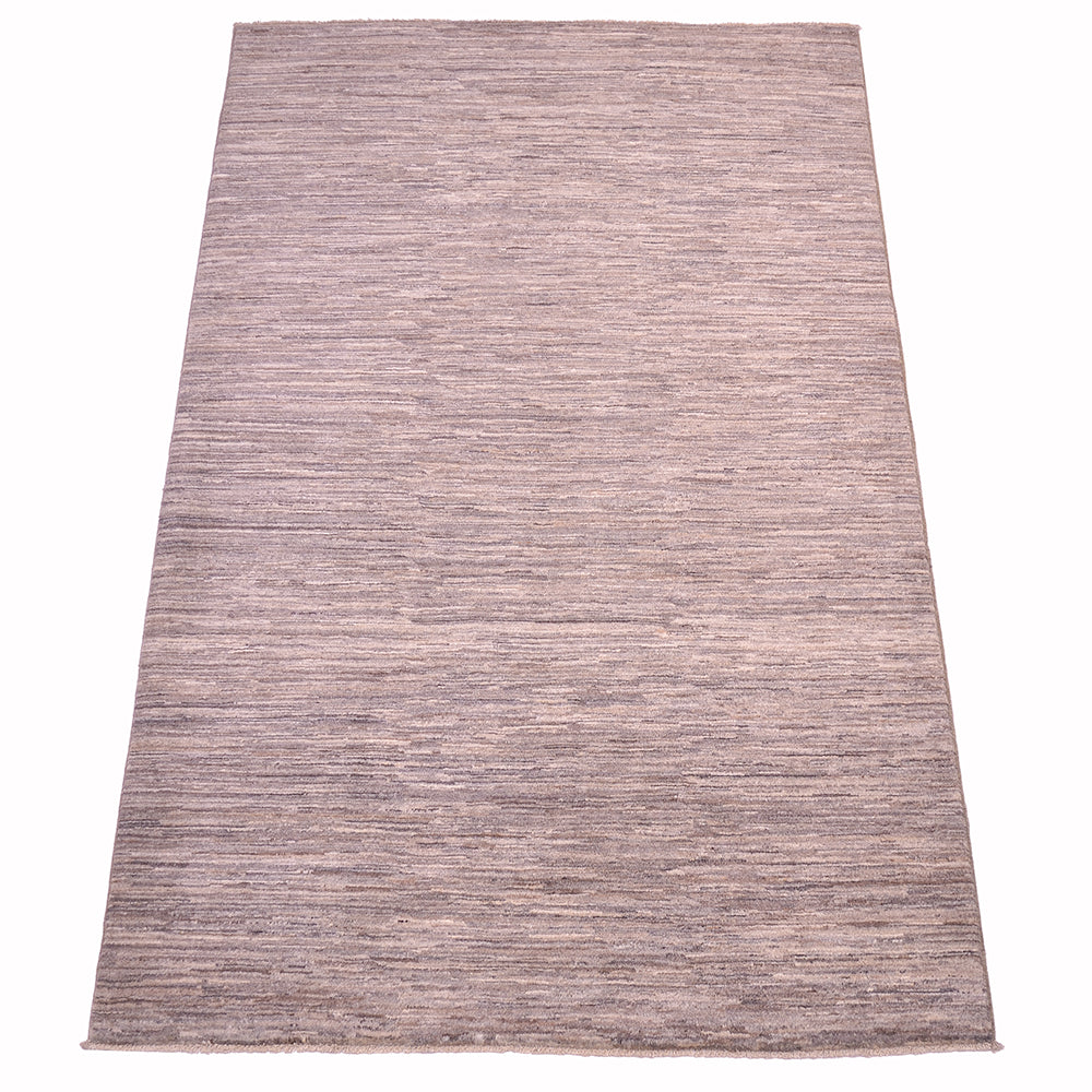 A 8x5 rectangular plain Gabbeh area rug with a textured pattern in muted dusty grey, beige and taupe tones, shown flat against a solid white background.