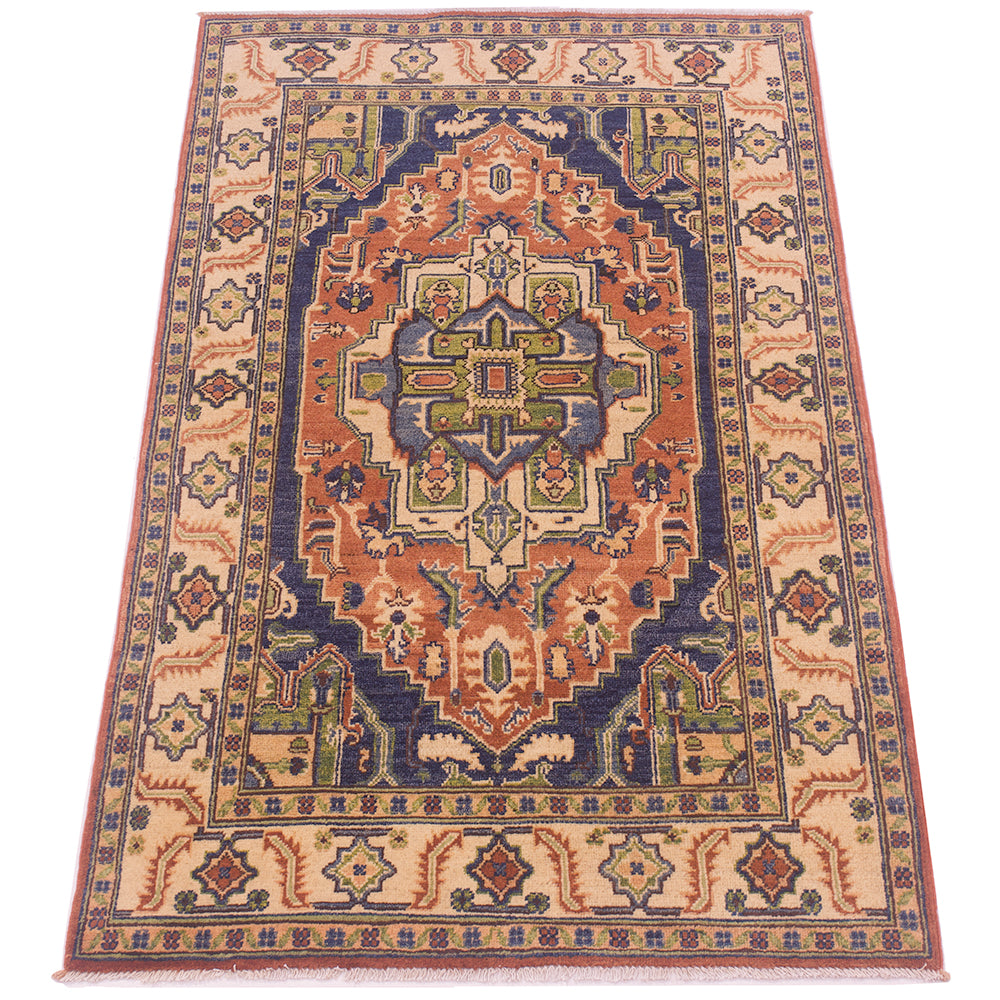 A traditional oriental-style heriz area rug with a complex geometric medallion pattern in navy blue, rust orange, beige, and green, shown flat against a white background.