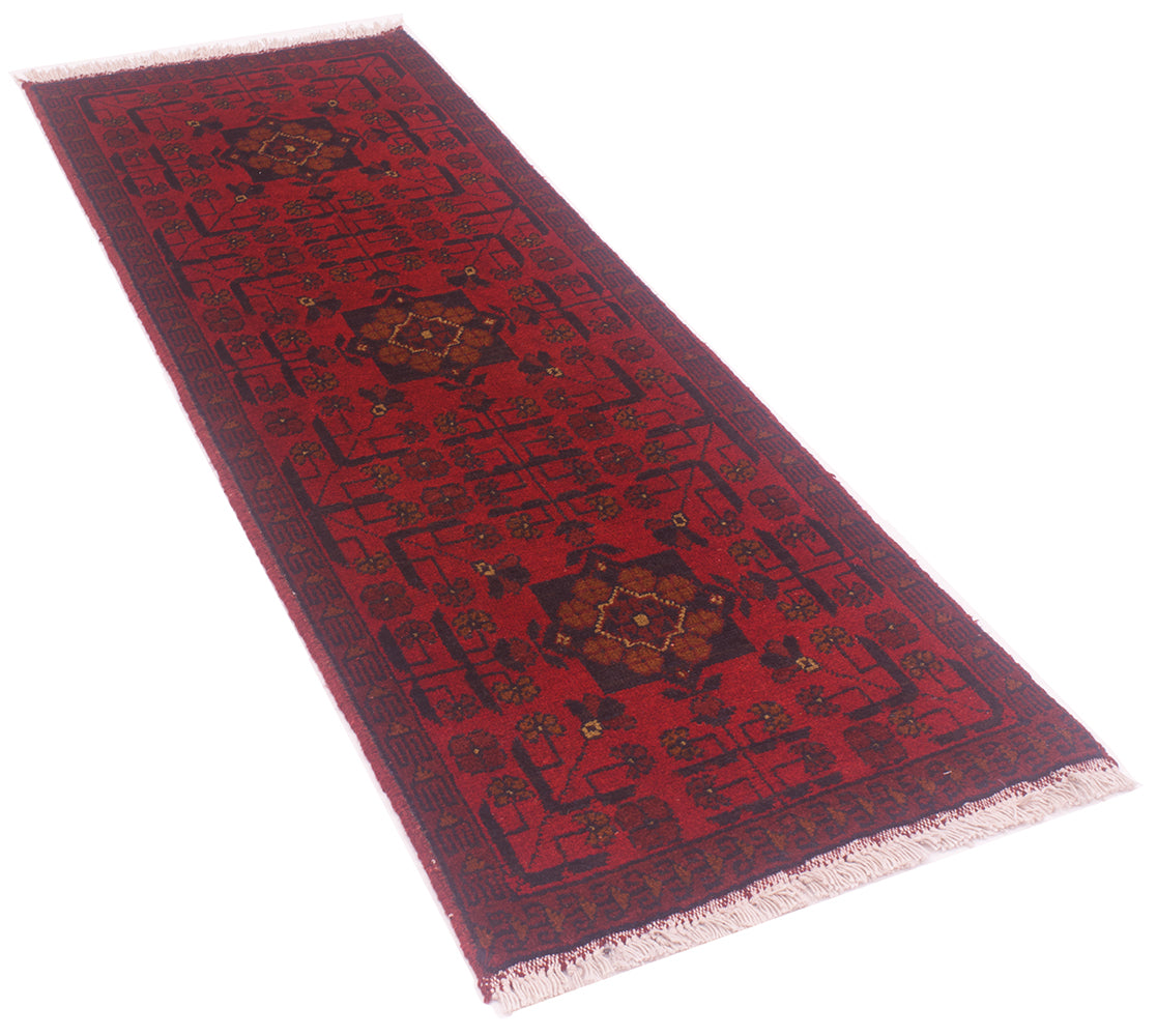 A short rectangular red runner rug with a dark navy border and central medallion motifs, shown on a plain white background.