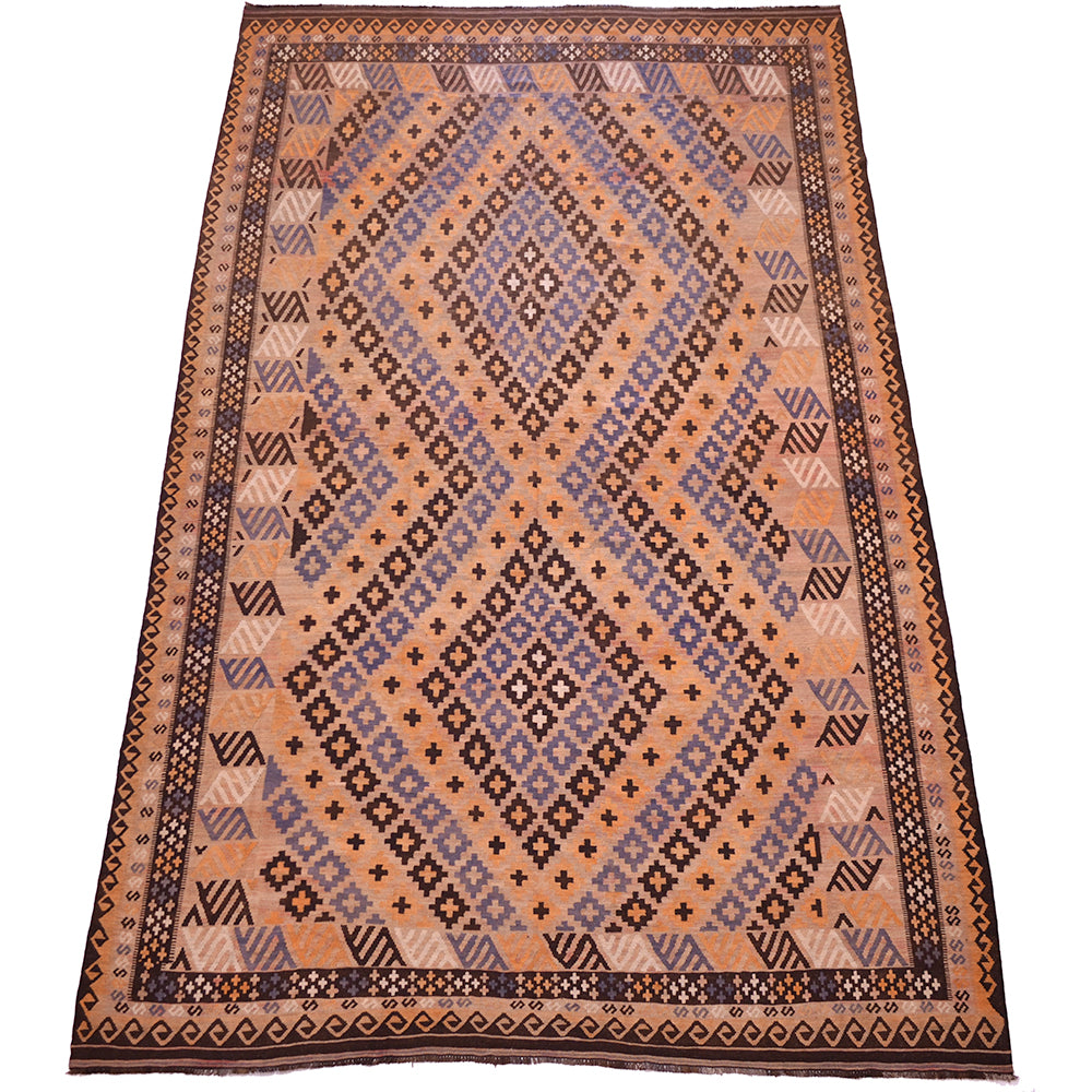 A rectangular hand-woven kilim rug with a geometric diamond pattern in terracotta, purple, brown, and beige, shown flat against a white background.