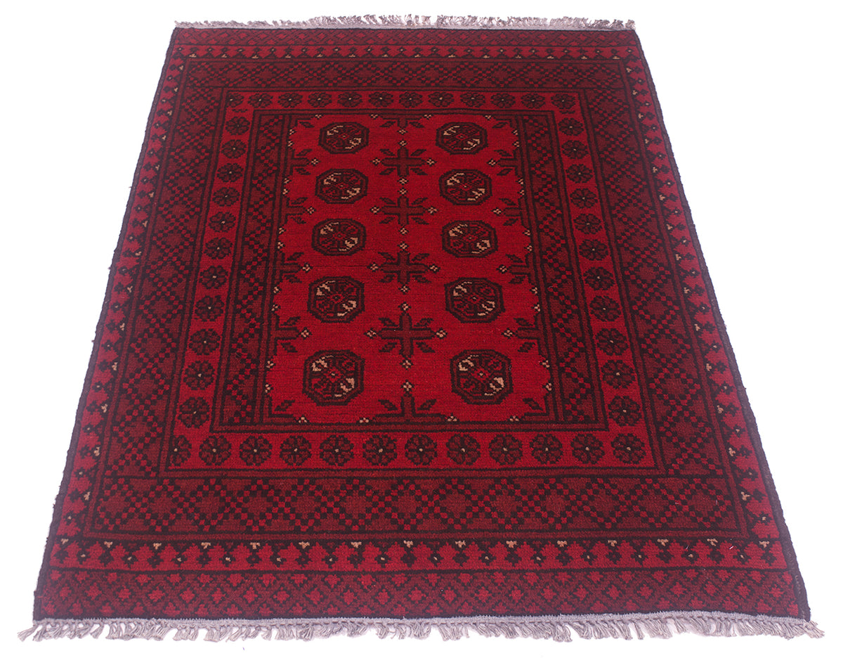 A traditional rectangular area red Afghan rug with a deep red field, dark navy and black geometric borders, and central bokhara motifs, finished with grey fringe on all sides.