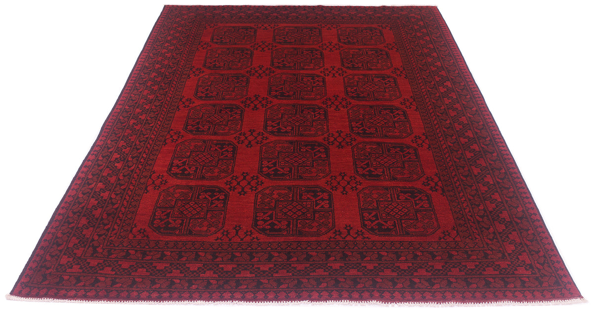 A 9x6 rectangular red Afghan Aqcha carpet with a black geometric pattern and border, shown flat against a white background.