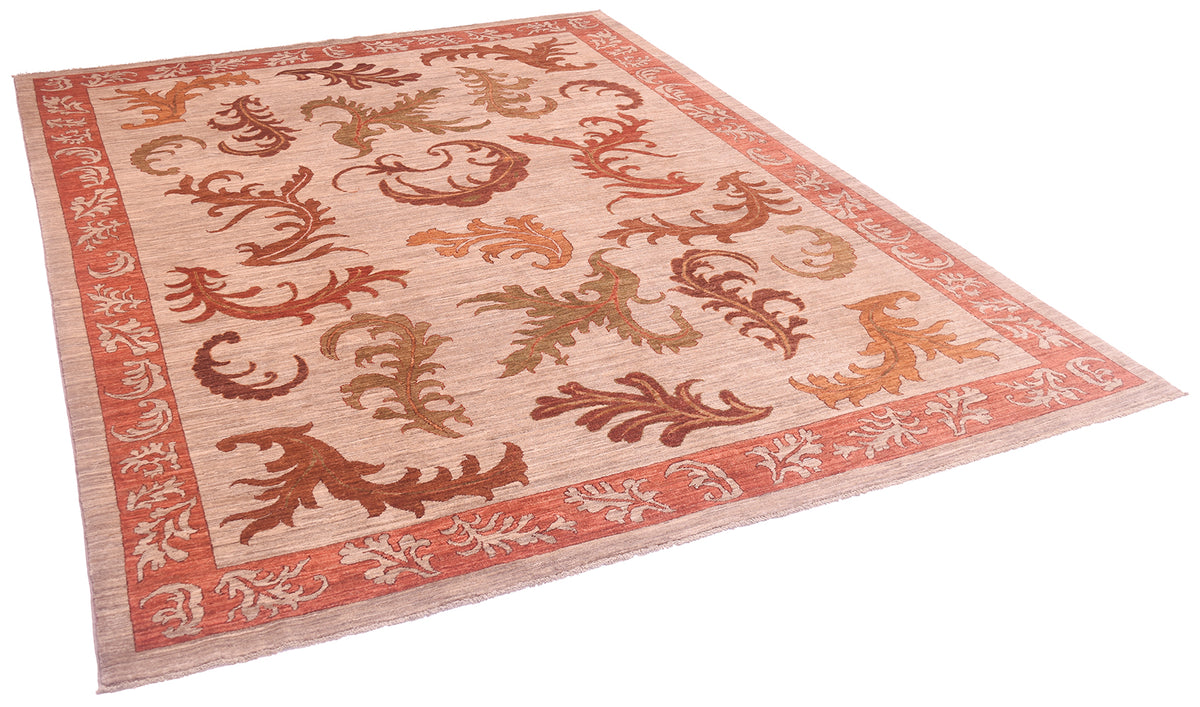 Angled view of handmade Arts and Crafts carpet on a white background showing beige-grey field clours wirh oversized leaves in bronze, amber, olive green and rust reds.