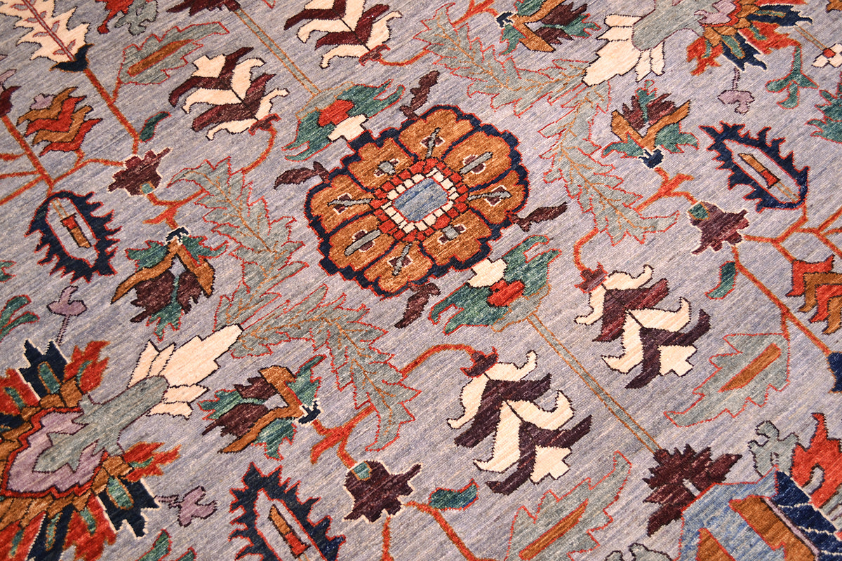 Close up detail of main field of Afghan with antique Persian design vocabulary with modern saturated colours. Angular palmette and leaves with lobed rosettes. Soft teal greens accents also in main field design.