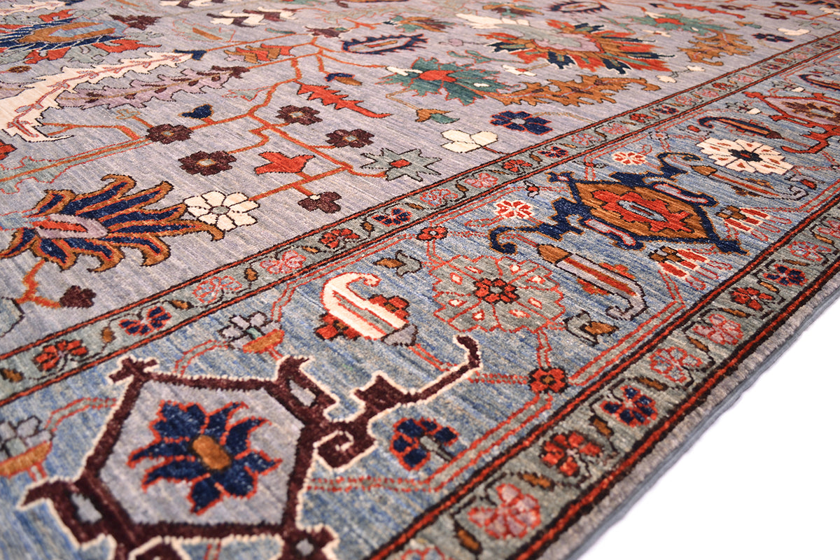 Detail of finely woven border of Afghan Aryana with antique Serapi design with cloudband border. Blue background with rosette and vine minor borders. Handknotted with natural vegetable dyes.