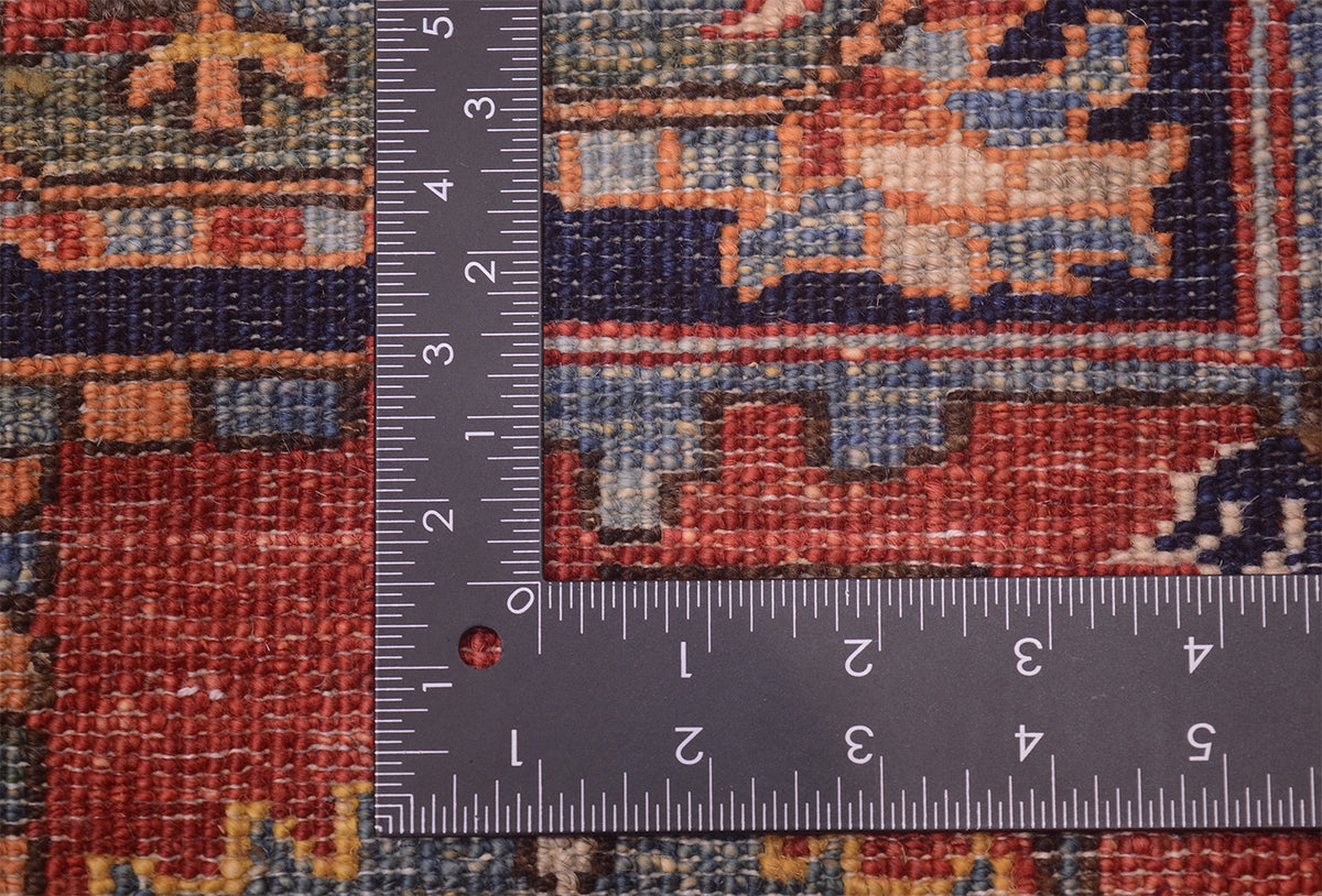 Rug surface with measuring tape; red, navy and beige geometric pattern