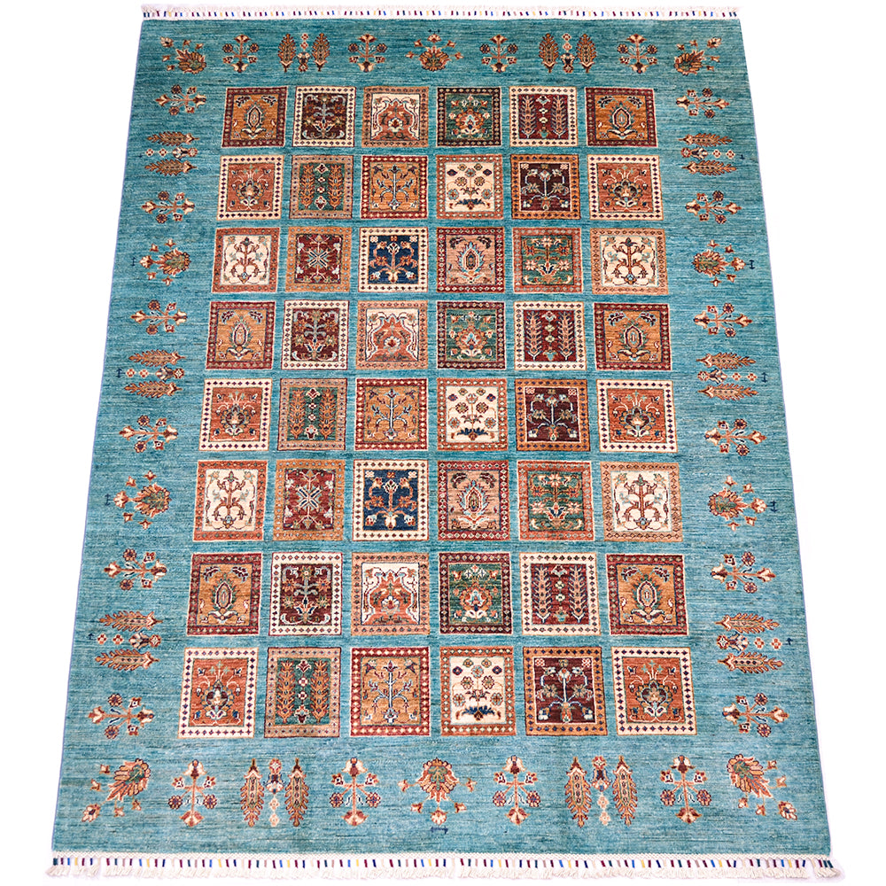 A 8x6 rectangular Afghan Bakhtiari area rug with a turquoise blue field and a grid of ornate square panels in rust, beige, navy, and cream, bordered by decorative motifs.