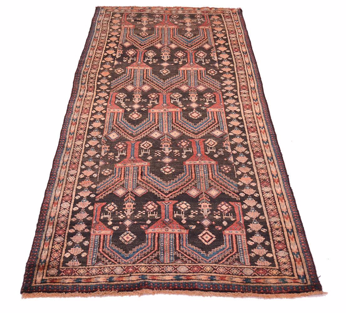 A traditional rectangular old Belouch wide runner rug with a dark charcoal field, featuring geometric patterns in red, beige, and teal, bordered by intricate geometric designs.