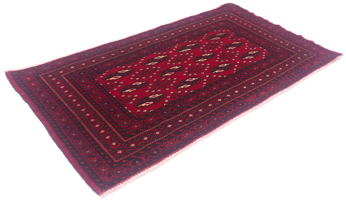 A rectangular Afghan Belouch mat with a deep red field, dark navy blue borders, and beige and brown geometric motifs, shown on a plain white background.