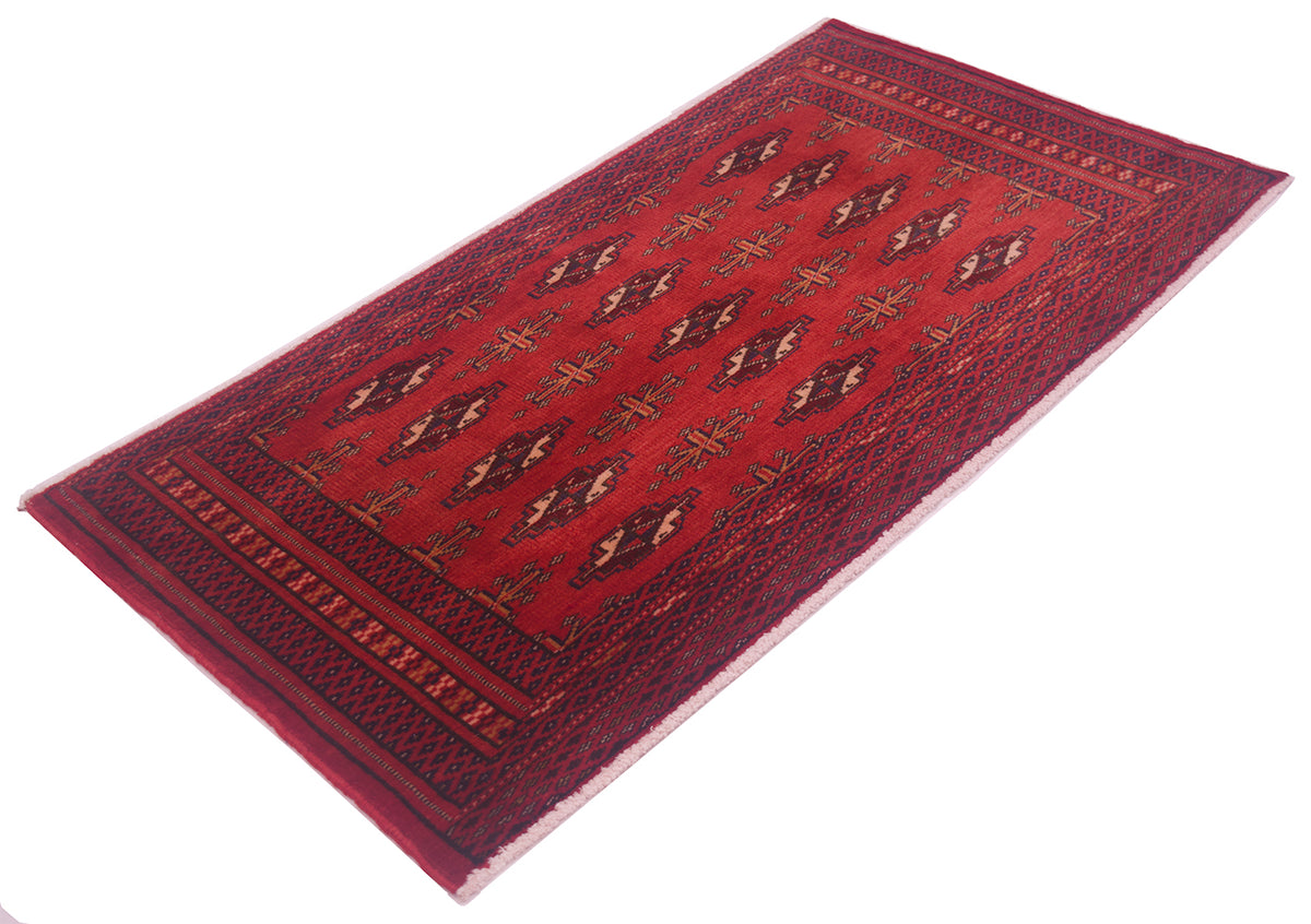A traditional rectangular handmade Afghan Belouch mat with a deep red field, geometric diamond motifs, and a dark patterned border, shown on a plain white background.