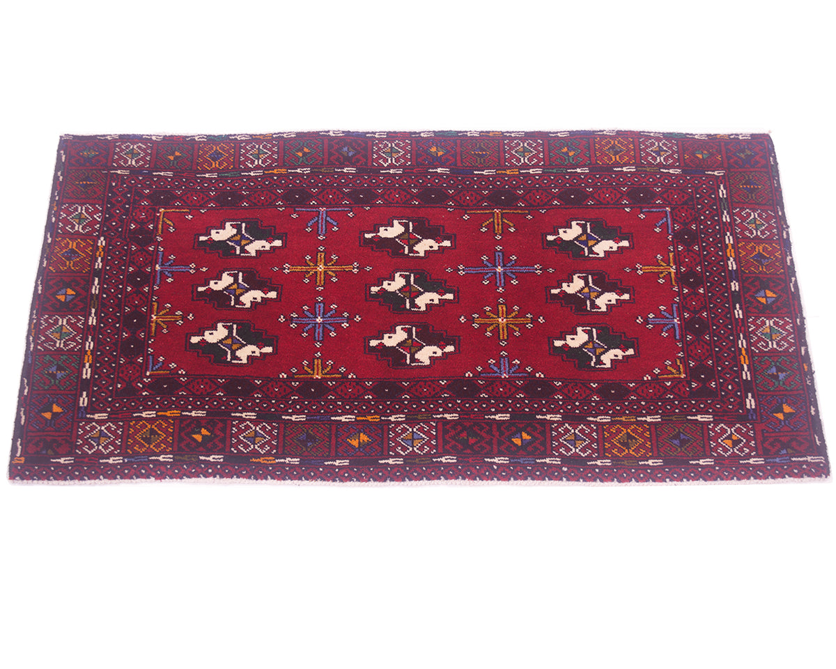 A rectangular red oriental Afghan Belouch small rug/mat with a geometric border and central field featuring stylised motifs in black, cream, blue, and orange, photographed flat against a white background.