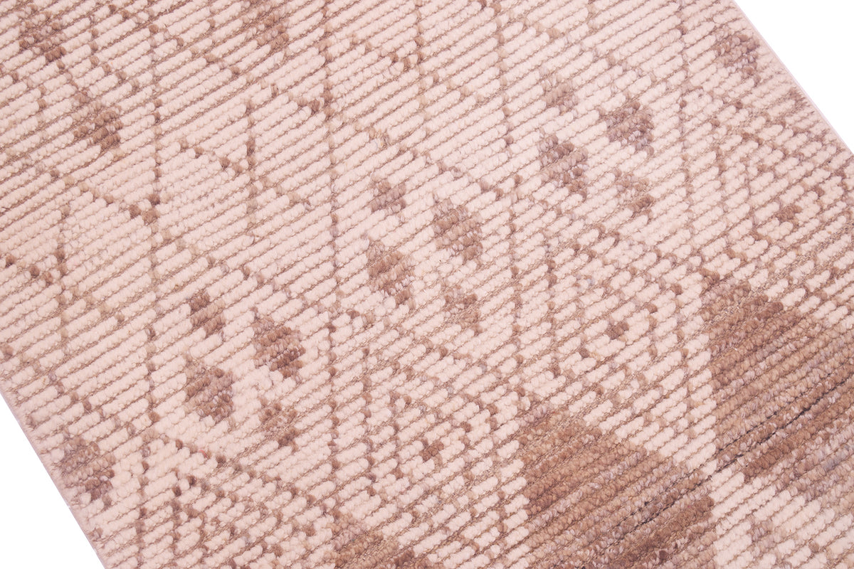 A close-up of a woven textile with a geometric diamond pattern in beige and taupe brown.