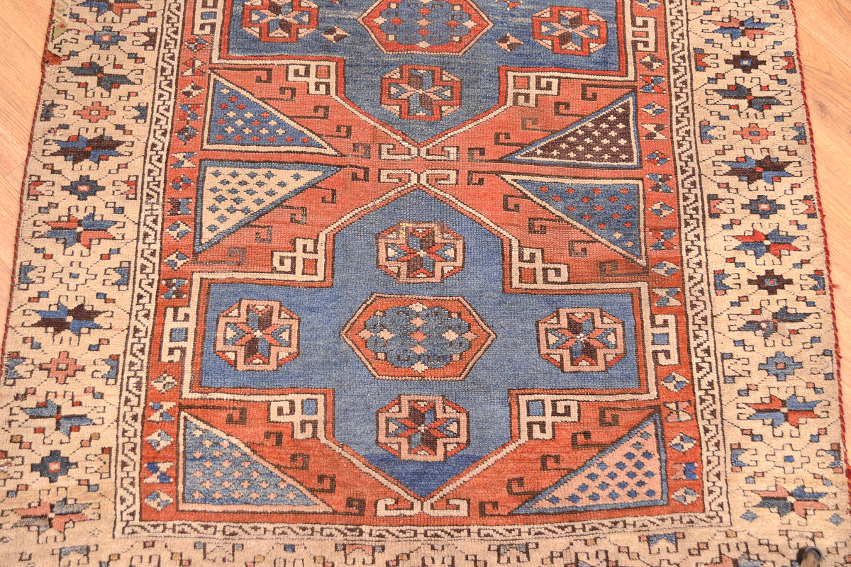 Antique Bergama rug center medallion close-up with geometric arrows and star motifs