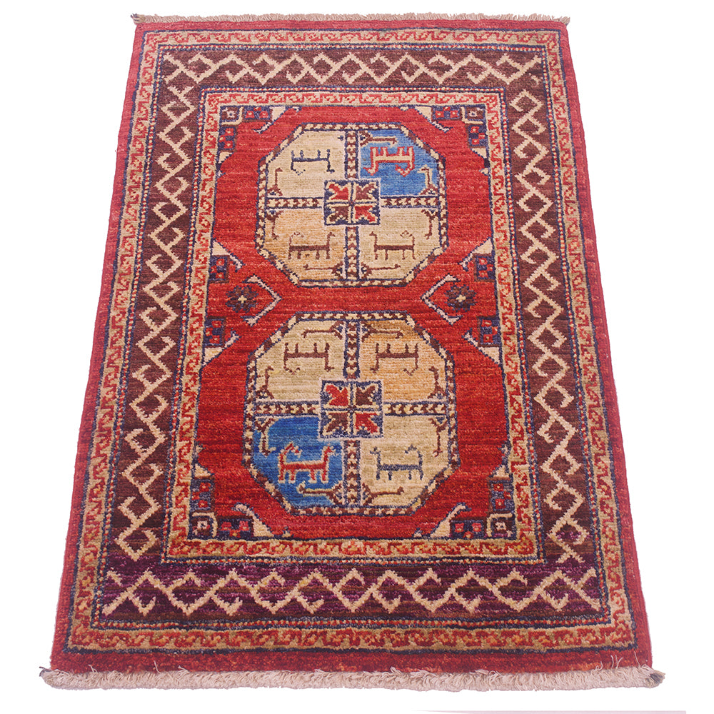 A traditional rectangular wool Afghan Fil Pai small rug with a rust-red field, two large central medallions, and a patterned border. The medallions feature beige, blue, and red geometric motifs.