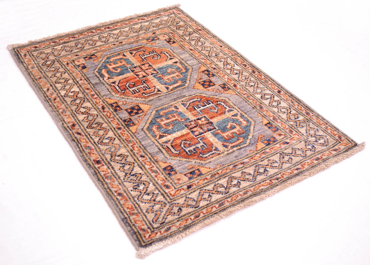 A traditional style Fil Pai Afghan Mat with a traditional geometric pattern, featuring a muted blue-grey field, rust-orange and navy blue motifs, and a patterned border, shown on a plain white background.
