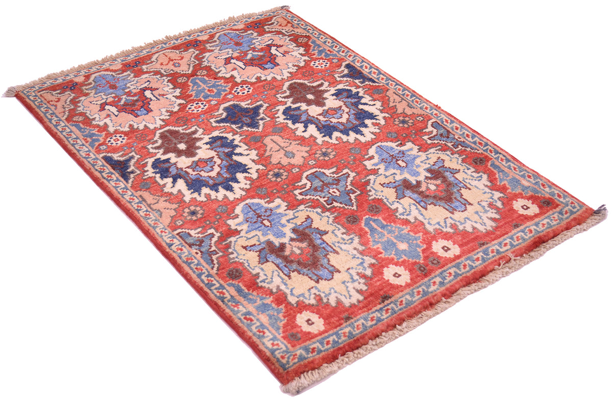 A rectangular Persian-style Afghan Chobi mat with a rusty-red field, blue and beige floral motifs, and a patterned border, shown on a plain white background.