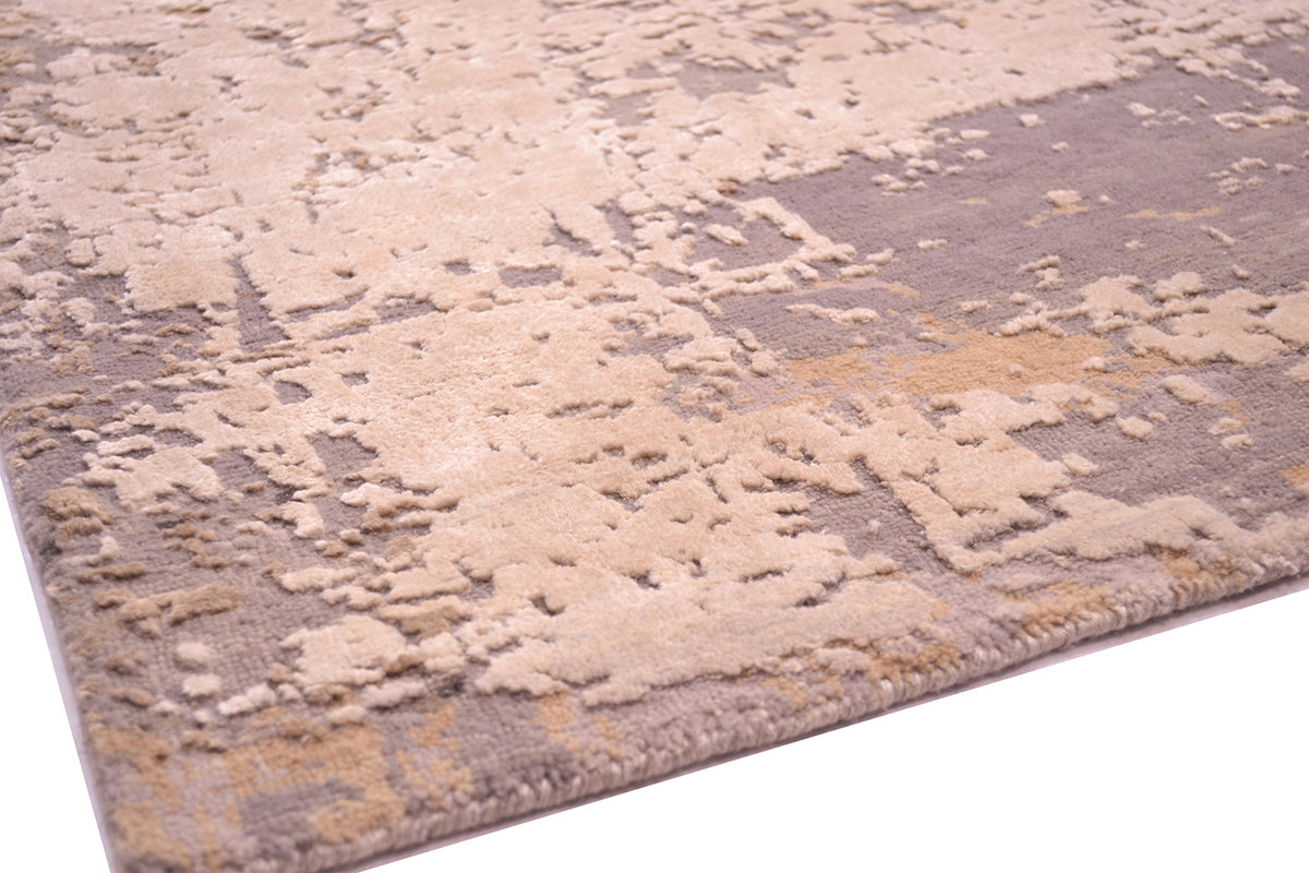 Detail and close up of wool and silk pile showing raised pure silk areas in ivory cream pure silk, with grey and beige taupe/ fawn. Luminous silk highlighted areas.
