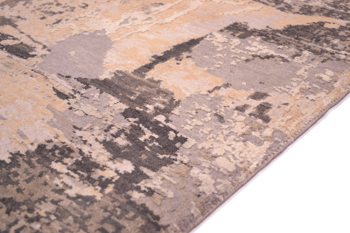 Detail of handknotted abstract rug with raised silk highlights hand cut with clay and charcaol tonalities with beige taupe nut browns. Pure woll pile and pure silk in pile.