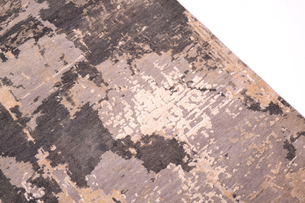 Expressionistic abstract hadnwoven carpet with clay greys and light natural earthy tomes of beige and taupe.