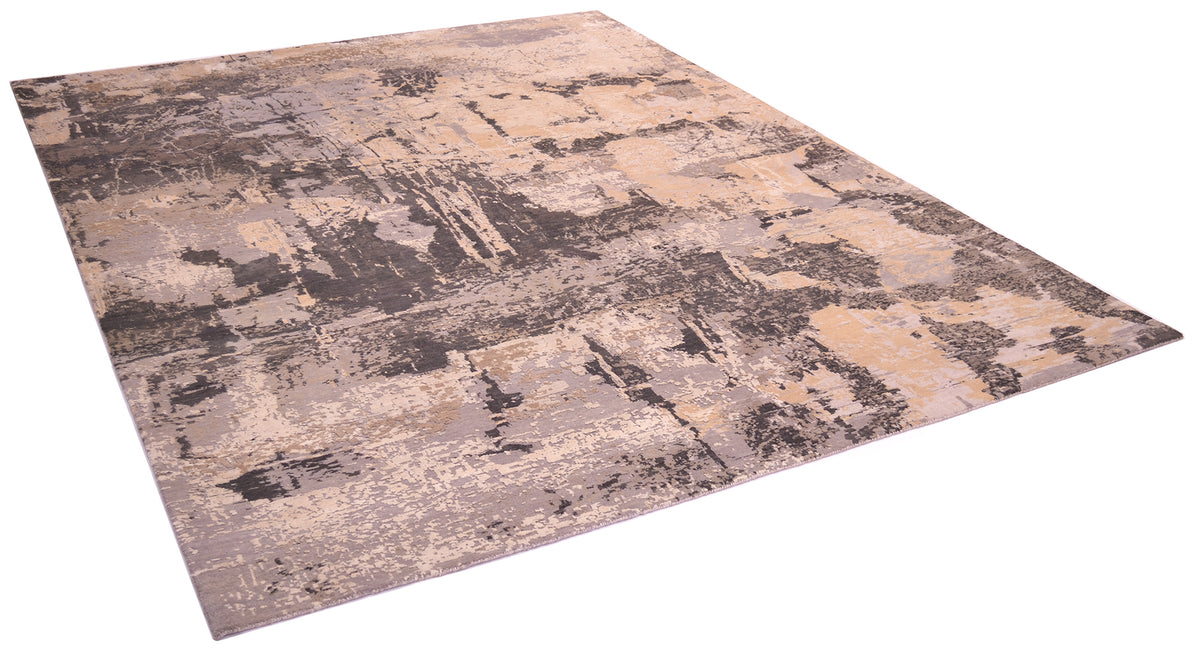 Angles view onf handkntted carpet with mid to ligth greys and mid to light browns pure wool pile with raised handcut silk areas for texture and visual luminosity.