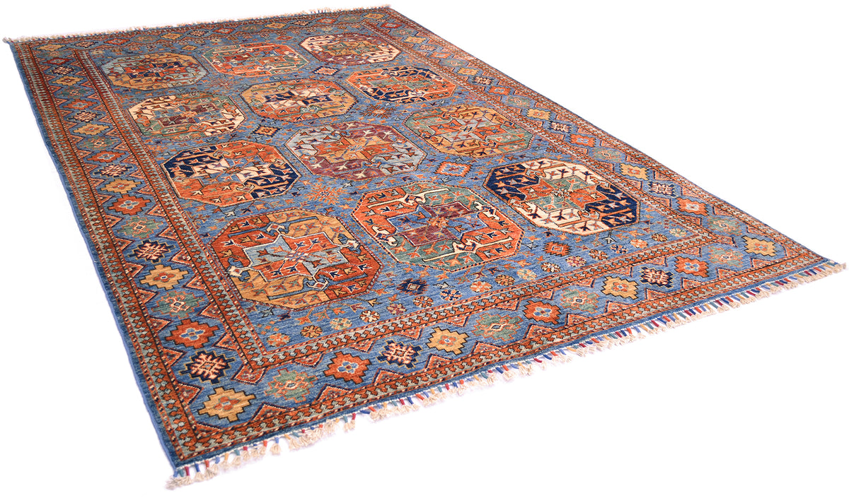 A traditional Afghan Ersari area rug with a complex geometric and floral pattern, featuring a blue border, orange and red central gul motifs, and cream fringe on a white background.