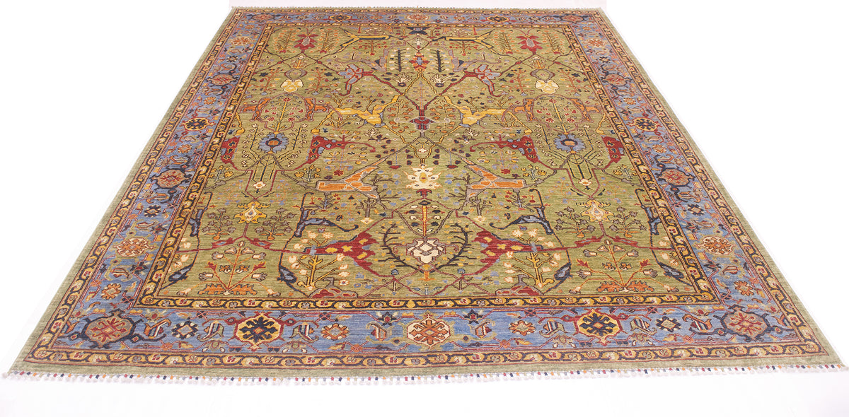 Overall view of magnifient classic design garous style carpet in soft green and blue border. Handmade with botanical designs.