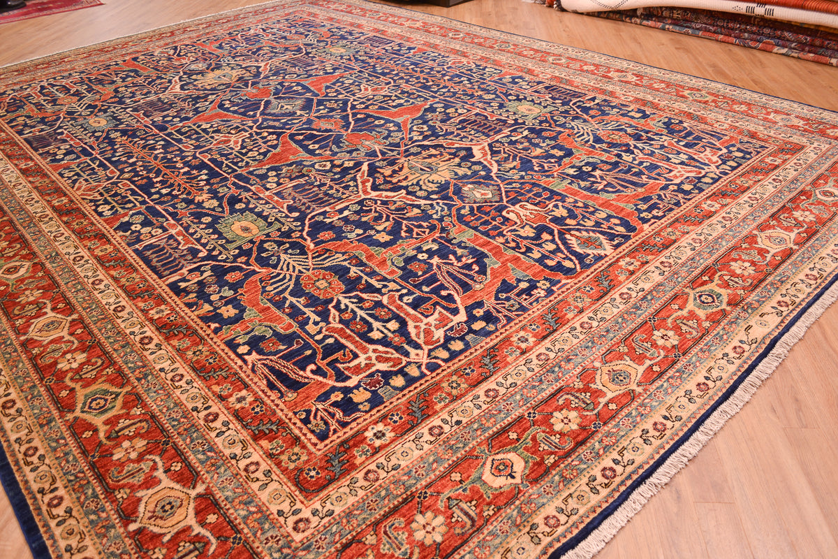 Angled view of large handknotted carpet with antique Persian garous design. With multiple borders and rich dark blue field colour.