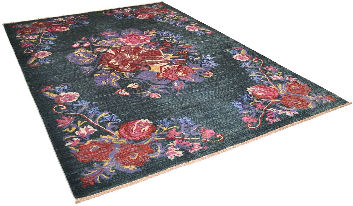 A rectangular area Afghan floral rug with a dark green background and an ornate floral pattern in red, pink, purple, and blue, shown from an elevated angle on a white background.