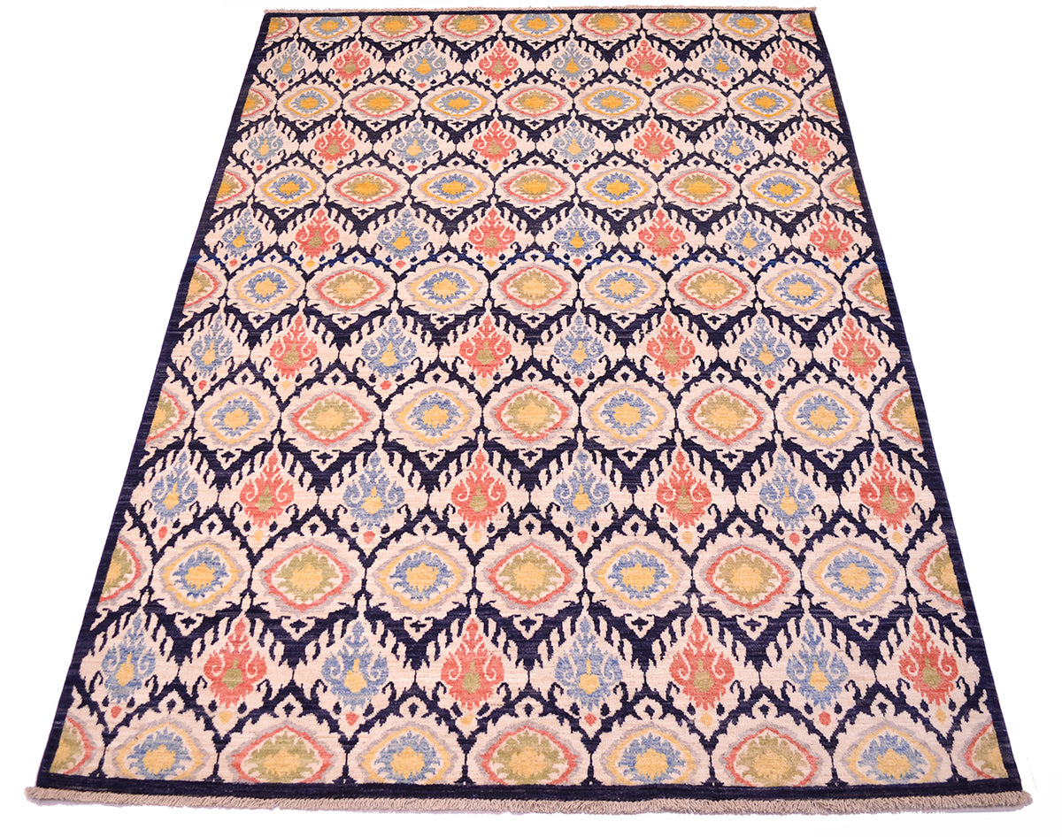 All-over ikat textile inspired handmade carpet from Afghanistan with varity of pleasing colours of cream, blues, terracotta corals, green and yellow. Flamelike ikat style all over medallion design.