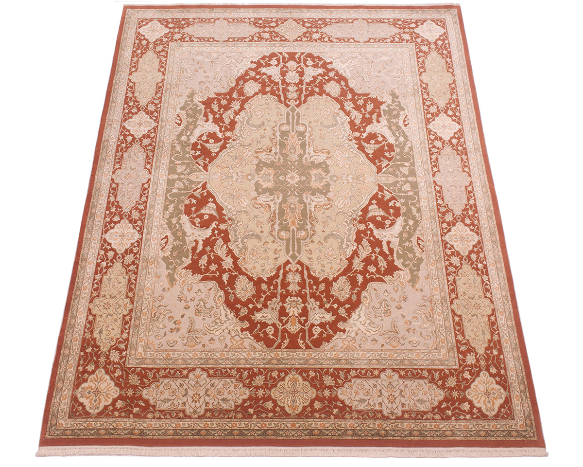 A traditional oriental-style area rug with an intricate floral pattern, featuring a central medallion and ornate borders in rust red, beige, and muted green tones.