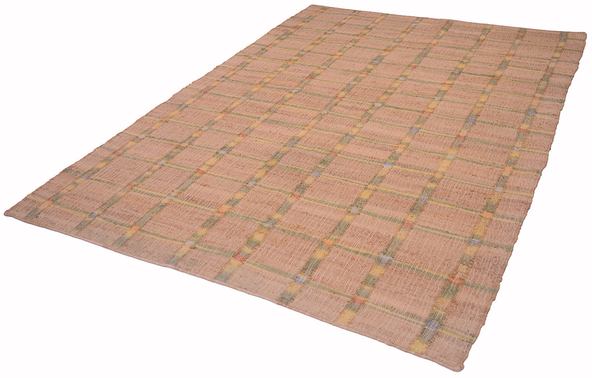 A rectangular woven rug with a warm tan and beige base, featuring a subtle plaid pattern in muted yellow, green, and gray tones, shown on a plain background.