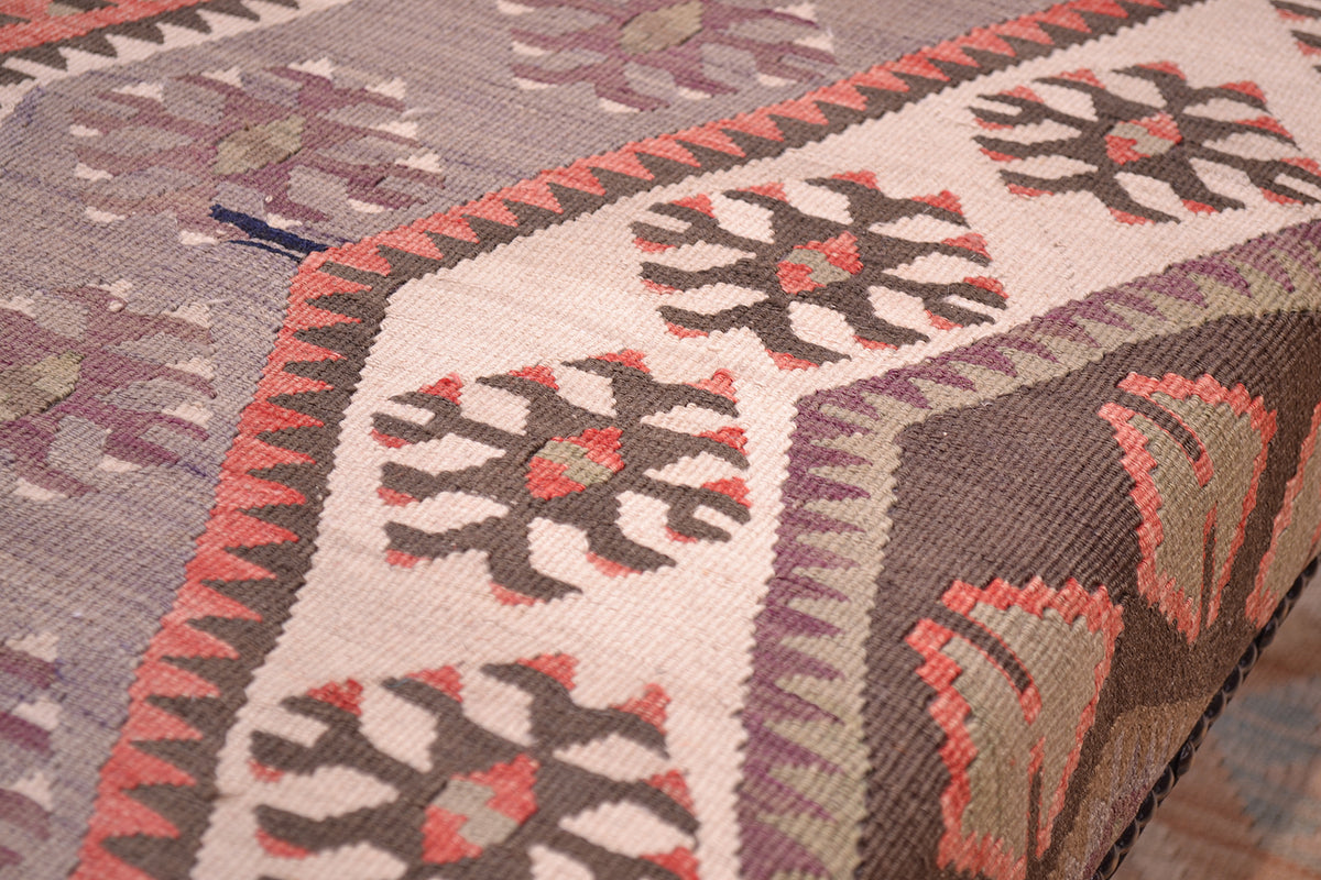 Detailed view of kilim bench with vontage kilim and natutal variations of softened tones in cream, brown, greys, mauves and chestnut.