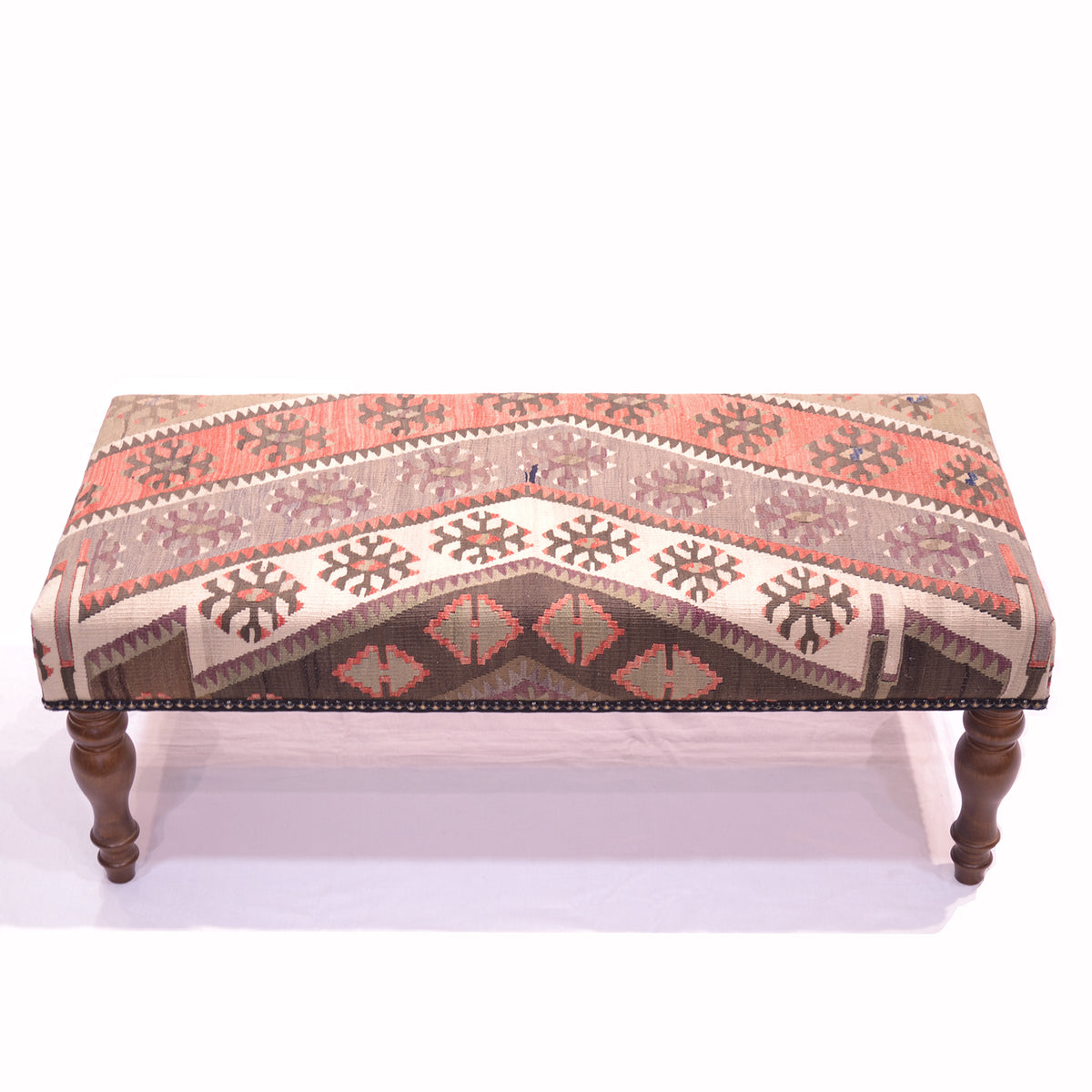 Kilim Bench Stool upholstered with a vintage Turkish Kilim in colours of cream, grey-mauve, soft light green and terracotta/ soft rusts. With a white background. Solid wooden legs.