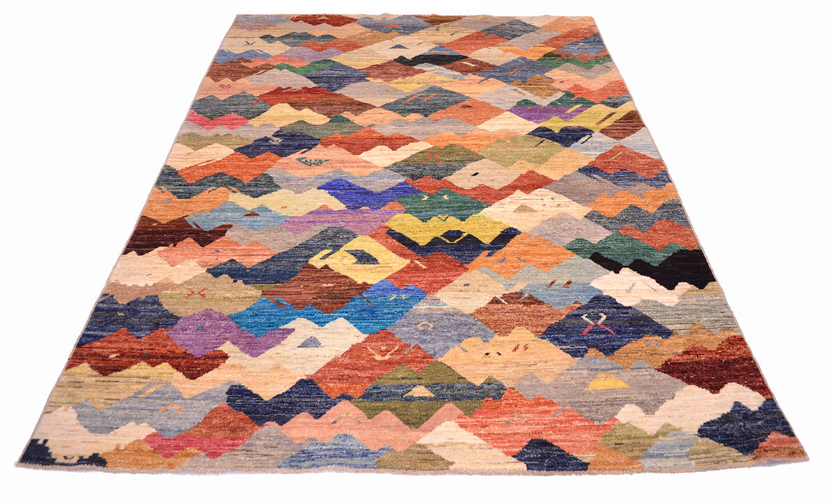 Over viiew of abstract coaretp handwoven in Afghanistan with array of earthy and vibrant colours with interlocking forms.