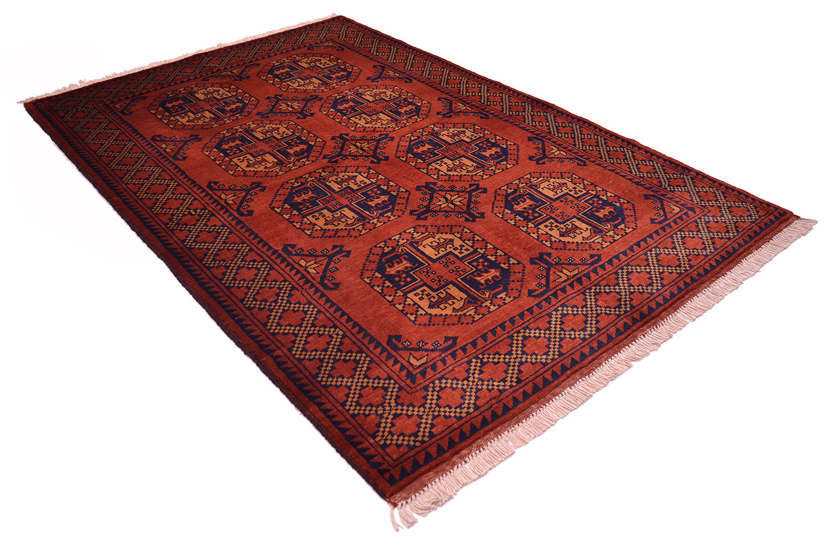 A rectangular wool Afghan Kargahi area rug with a traditional Ersari design, featuring a warm rust-red field, dark navy blue borders, and geometric motifs, shown on a plain white background.