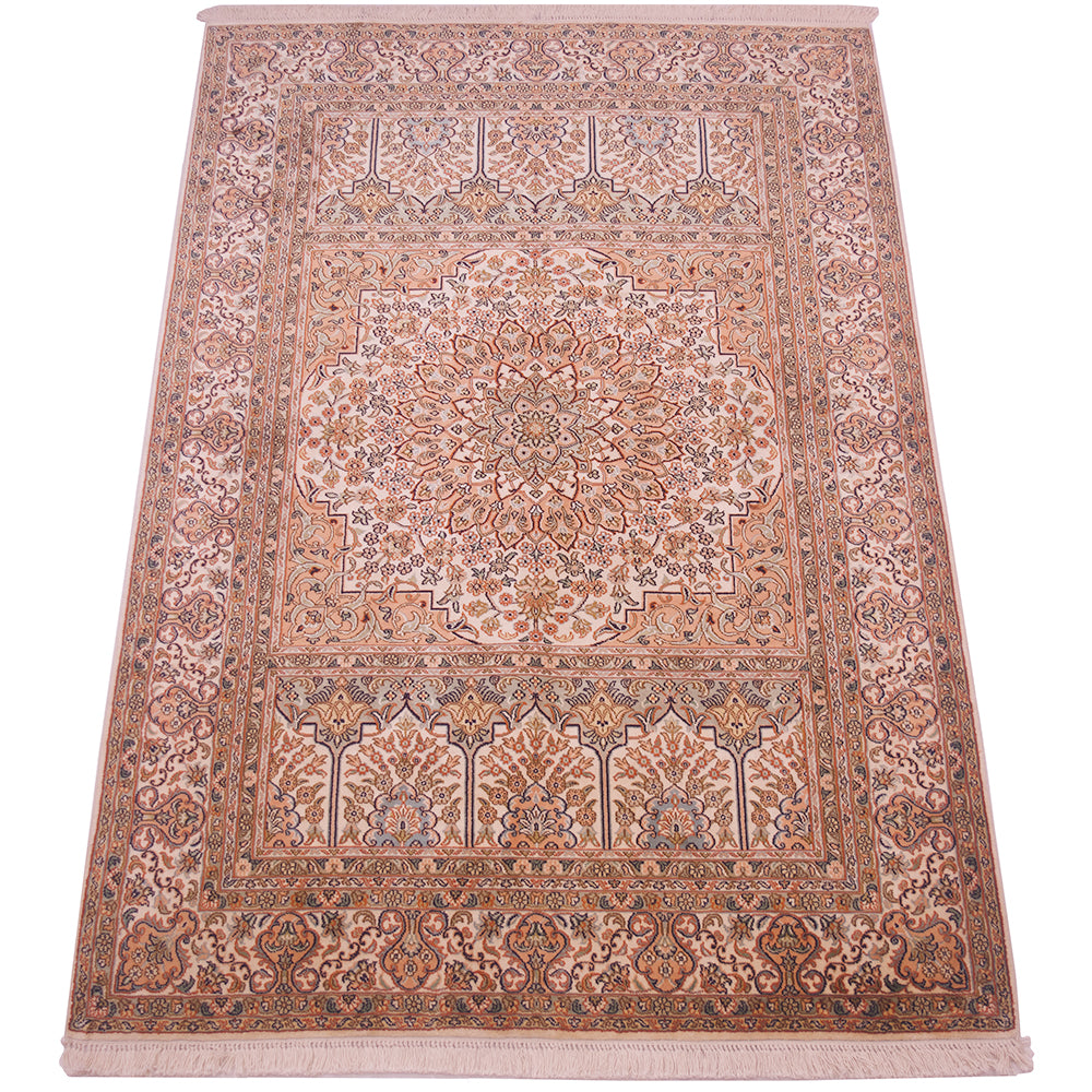 A traditional Kashmir rug with an intricate floral and geometric pattern in shades of beige, dusty pink, and muted blue, featuring a central medallion