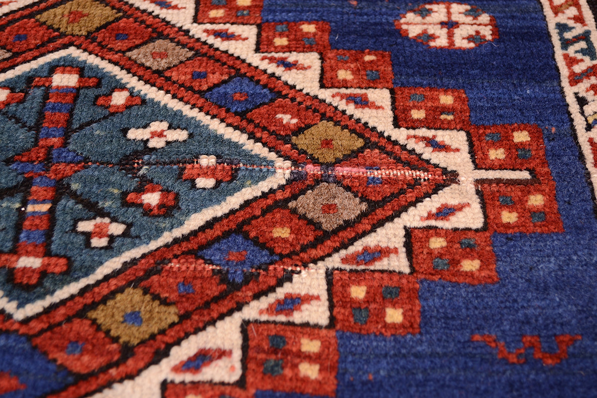 Detail of antique rug pile and wear commensurate with age.