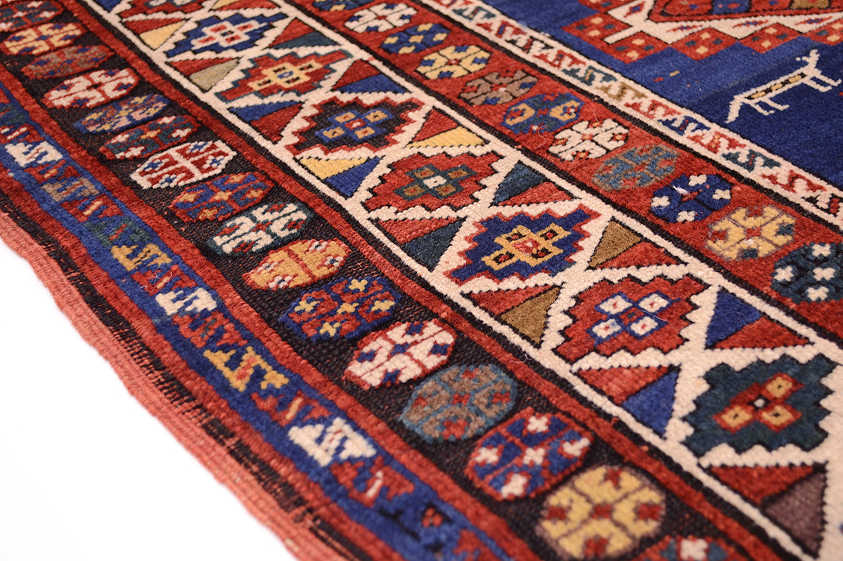 Detail of geometric border of antique kazak rug with roundels and miniature stepped medallions. Multiple borders and guard stripes.
