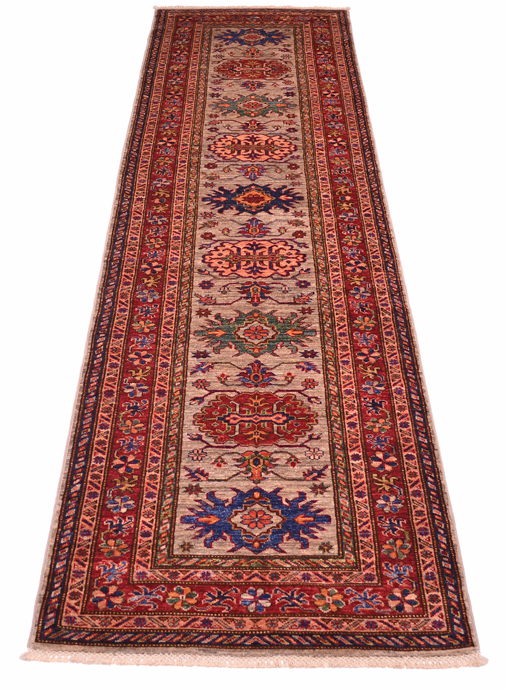 A traditional long Kazak runner rug with an intricate pattern, featuring a grey centre field, red borders, and blue and green medallions, shown flat against a white background.