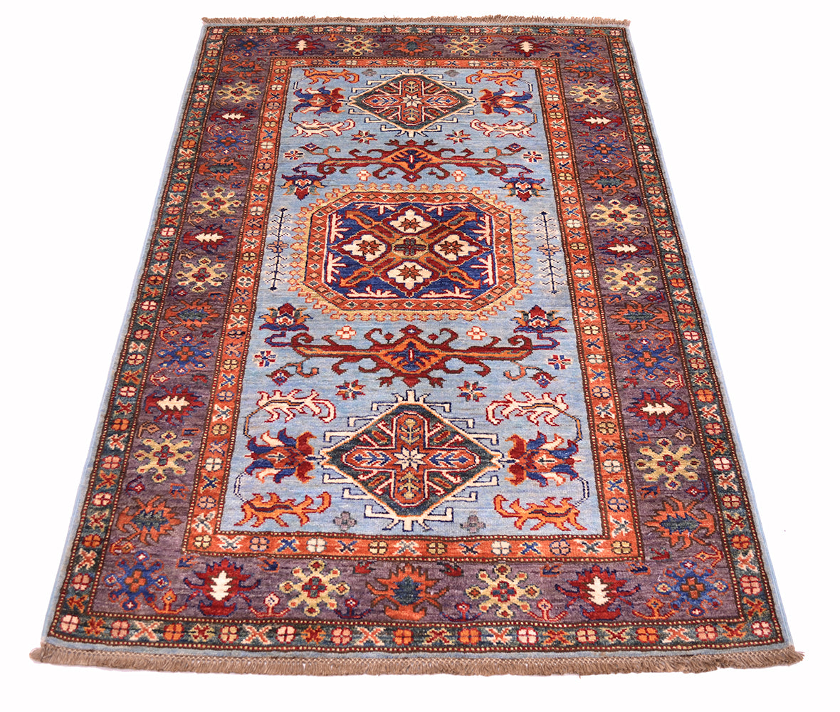 A traditional oriental-style fine Afghan Kazak area rug with a light blue field, red and aubergine borders, and multicoloured geometric motifs, shown flat against a white background.