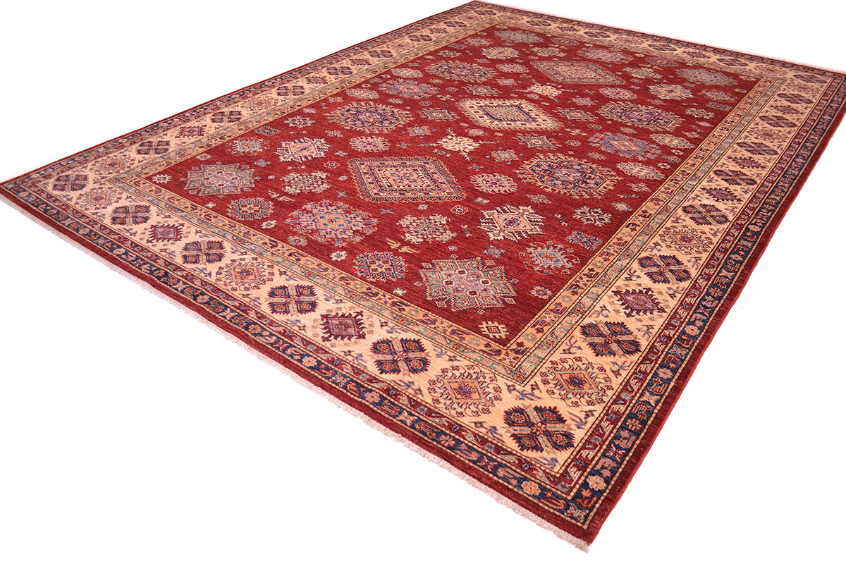 A traditional Large handmade red fine Kazak carpet with a deep red field, beige borders, and intricate blue and cream geometric patterns, shown from an elevated angle on a white background.