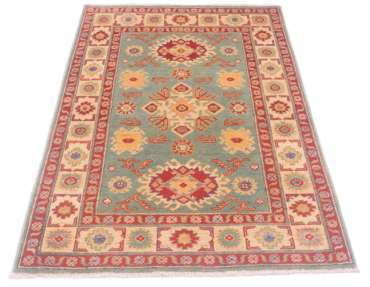 A rectangular Afghan Yakash Kazak rug with a traditional geometric pattern, featuring a sea-green centre field, red and beige borders, and cream fringe on a white background.