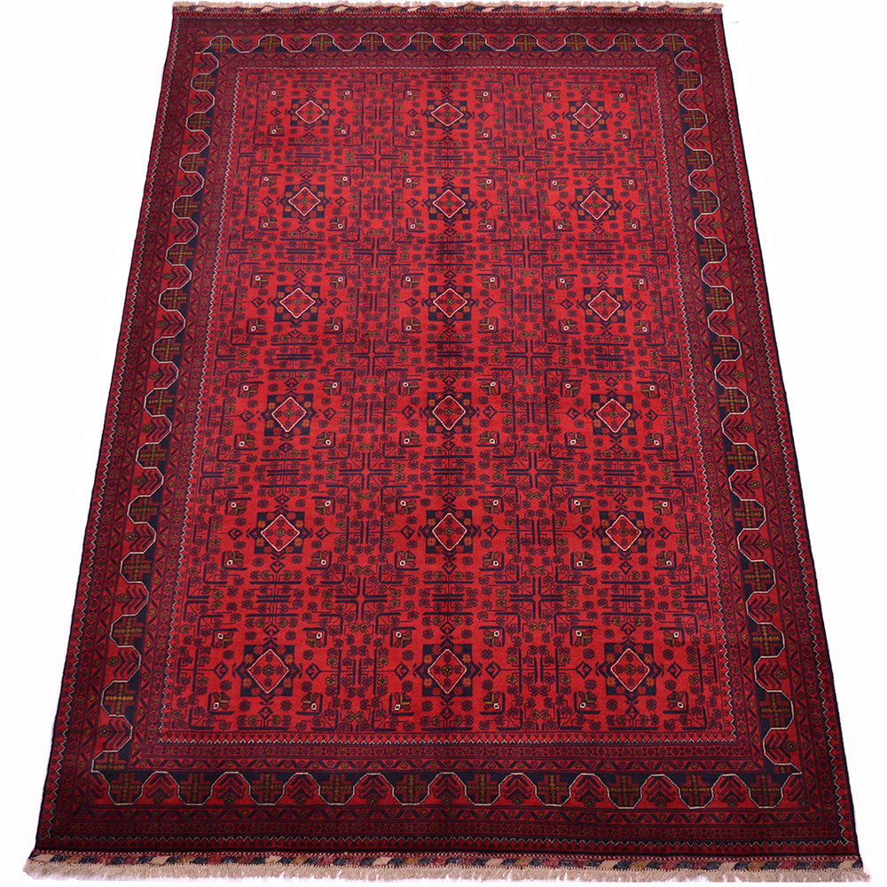 A traditional afghan area rug with a deep red field, dark navy blue geometric patterns, and a matching dark border with fringe on the top and bottom.