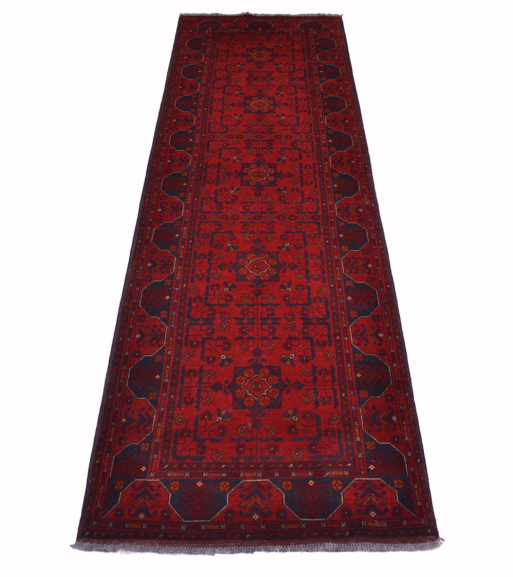A long red afghan runner rug with a traditional geometric pattern and dark navy borders, shown flat against a white background.
