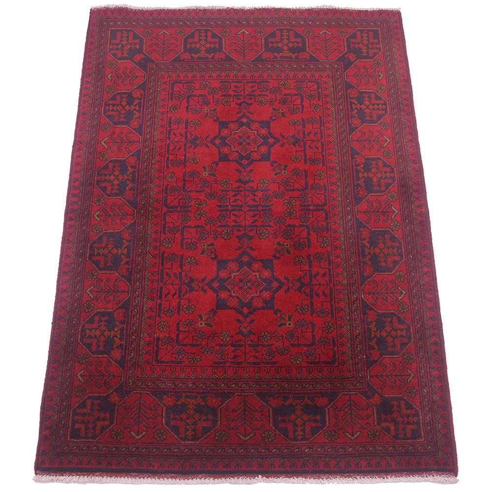 A rectangular red and navy blue patterned Afghan rug with traditional geometric borders and central medallion, shown flat against a white background.
